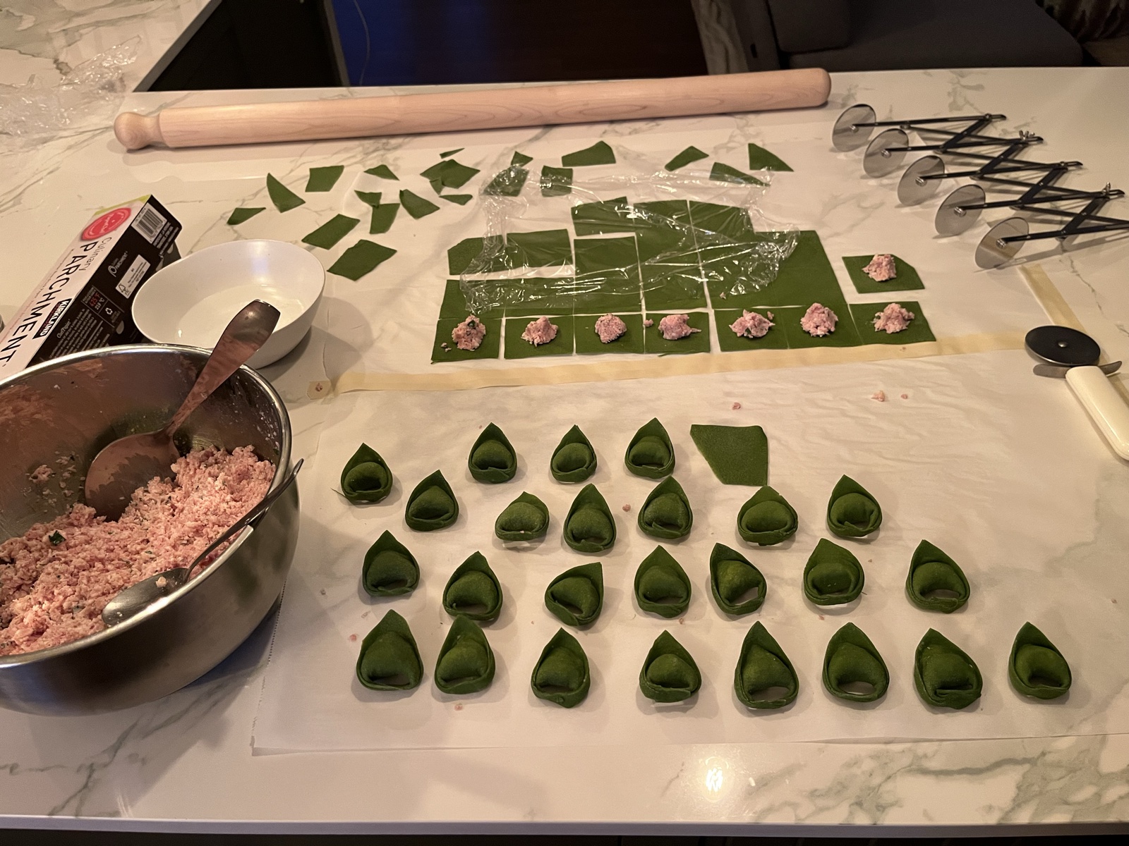 Spinach pasta with hand-stuffed ricotta filling, in progress.